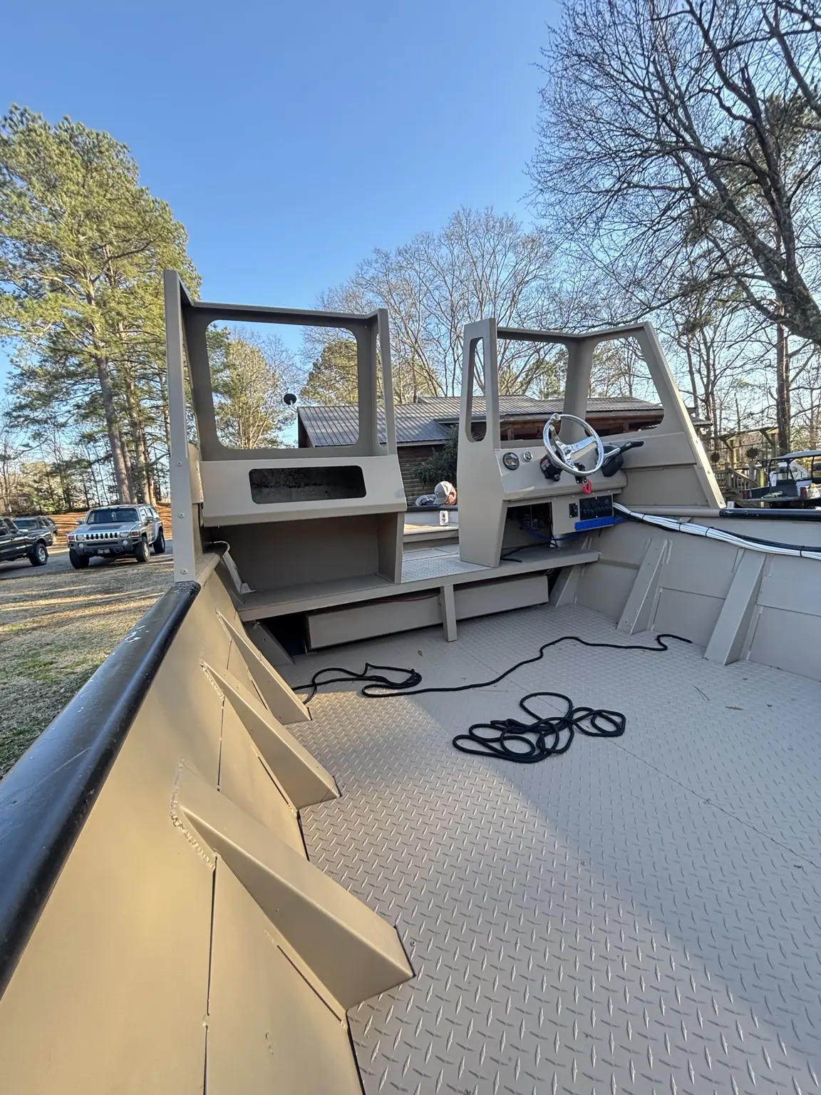 Finished custom aluminum boat interior with diamond-plate floor and fabricated helm consoles