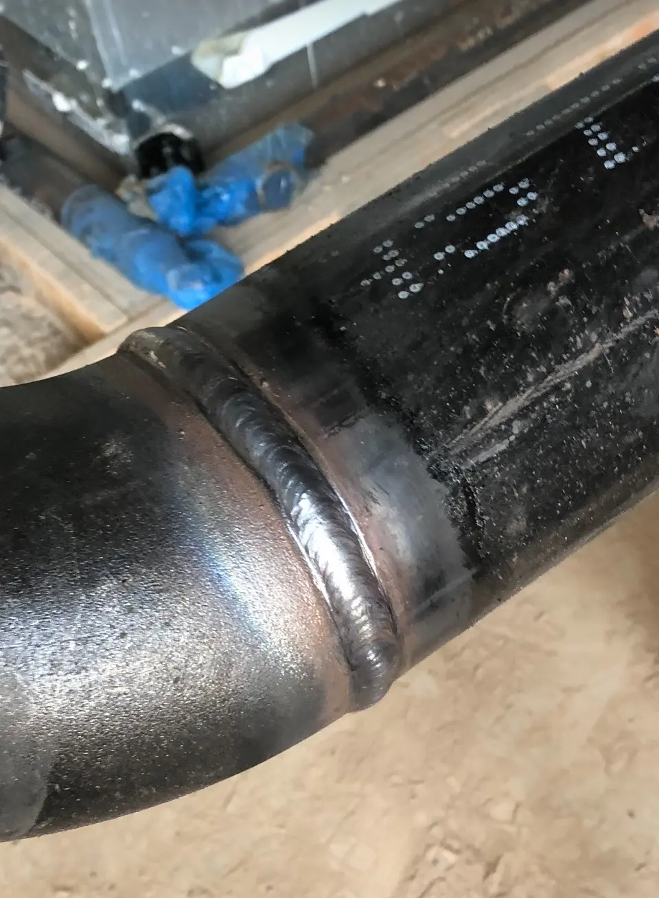 Close-up of a completed steel pipe weld